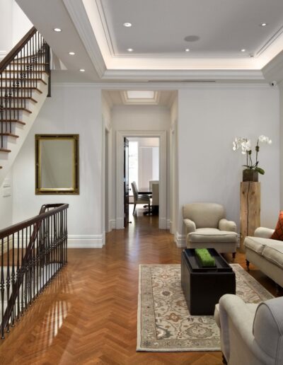 An elegant living room with a staircase and tasteful decor.