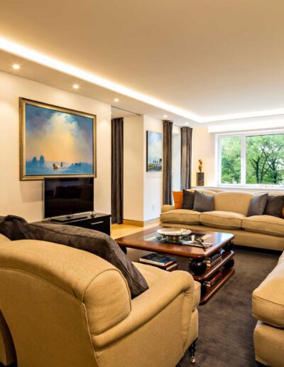 Bright and spacious living room with modern furnishings and large windows.